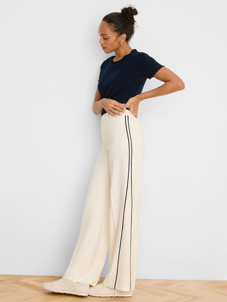 Ecru wide leg pants with black double piping down the outer seams.