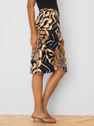 Tan, black, blue, and cream abstract pattern knit midi skirt.