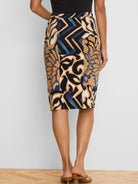 Black knit pencil skirt with tan, cream, and blue abstract pattern featuring fluid shapes and zigzags.