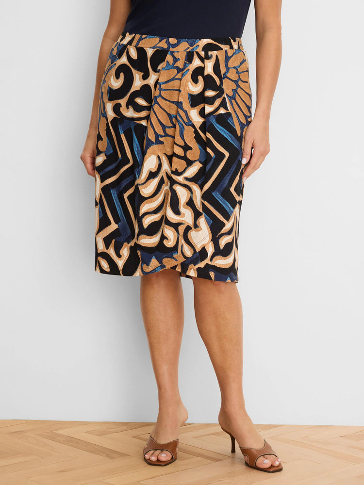 Knee-length knit skirt with an abstract deco pattern in black, tan, blue, and cream colors.