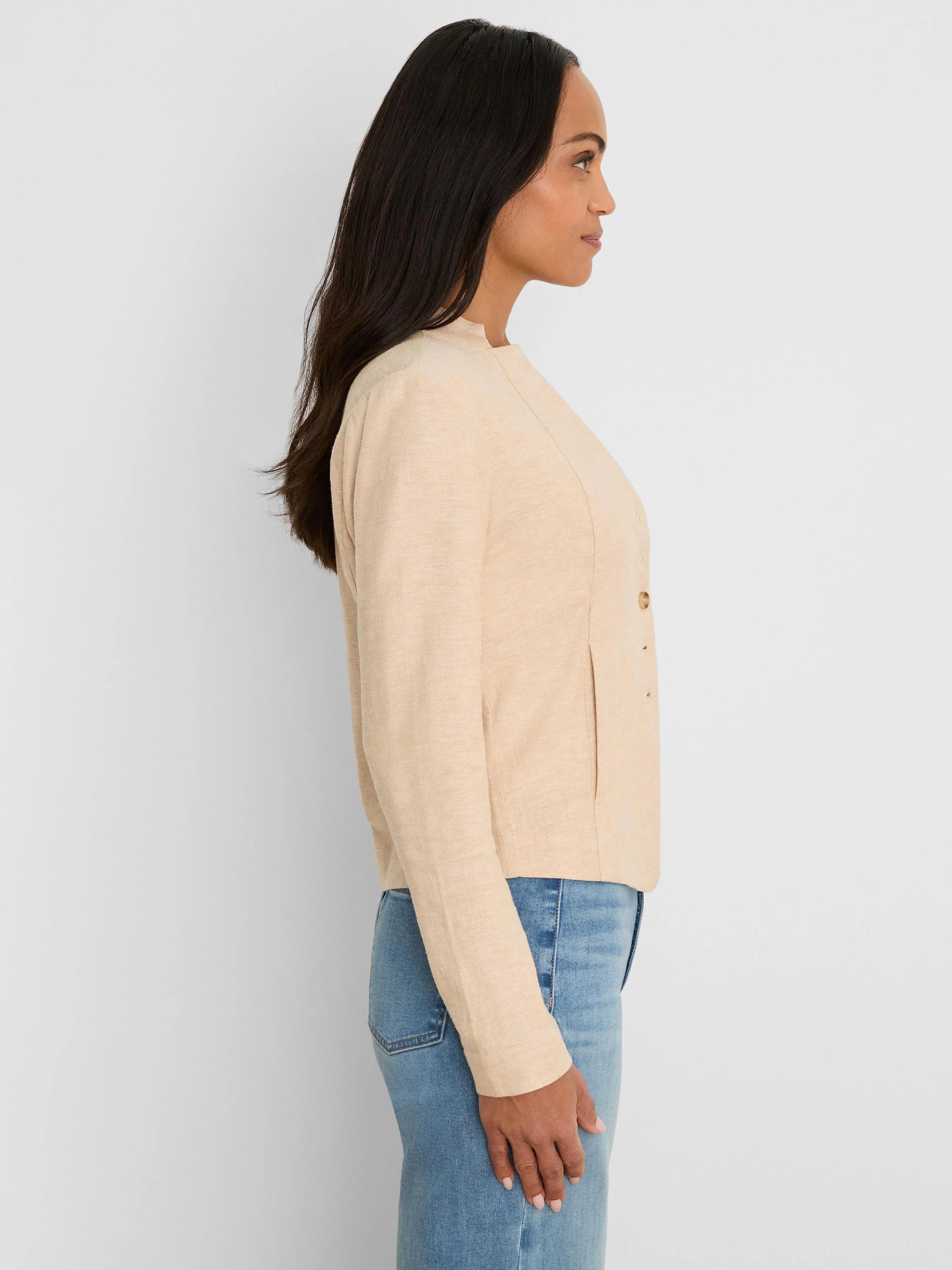 Light beige stretch linen jacket, collarless with rounded neck, long sleeves, front seam, and two small buttons.