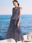 Navy smocked top with grey leopard sketch pattern, ruffled collar V-neck, and sleeveless design.