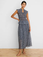 Navy smocked top with white leopard sketch print, mock neck, V-notch, and ruffled cap sleeves.