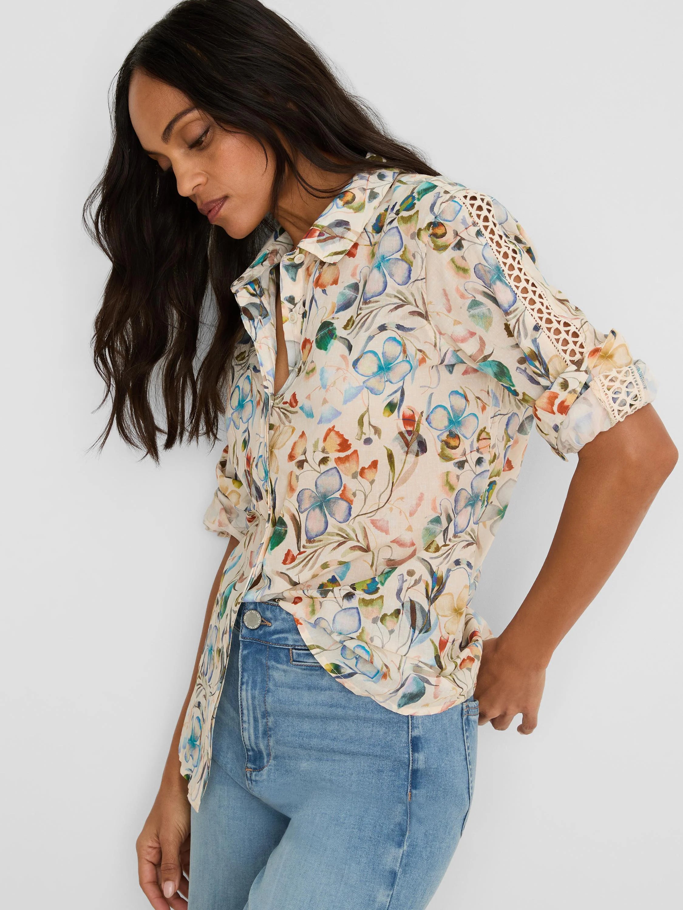 Off-white cotton lawn shirt with multicolor pressed flower print. Collared, with rolled sleeves showing lace cutwork.