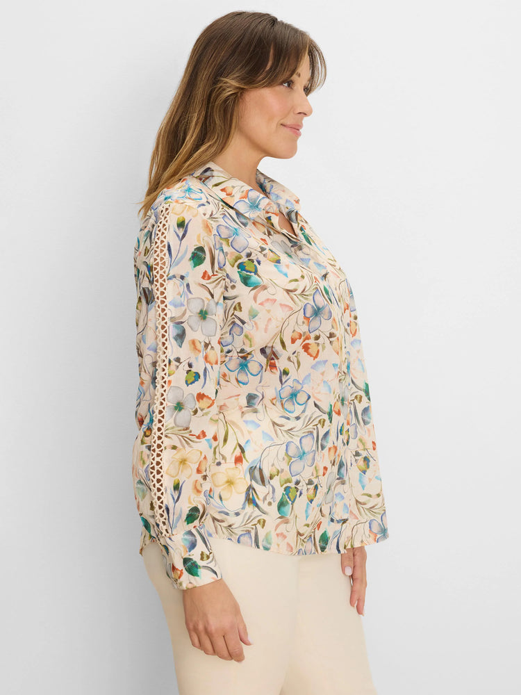 Light beige shirt with muted blue, orange, green pressed floral print. Features decorative lace inserts on sleeves.