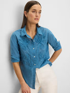 Dusty blue collared shirt with button-front, featuring fabric flower appliques and small beads on the front.