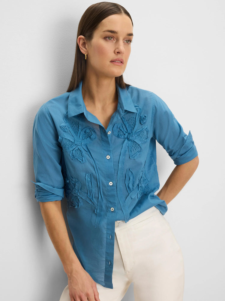 Dusty blue collared shirt with button-front, featuring fabric flower appliques and small beads on the front.