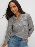 Light top with blue, black & tan speckles, ruffle neck & 3 pearl buttons.