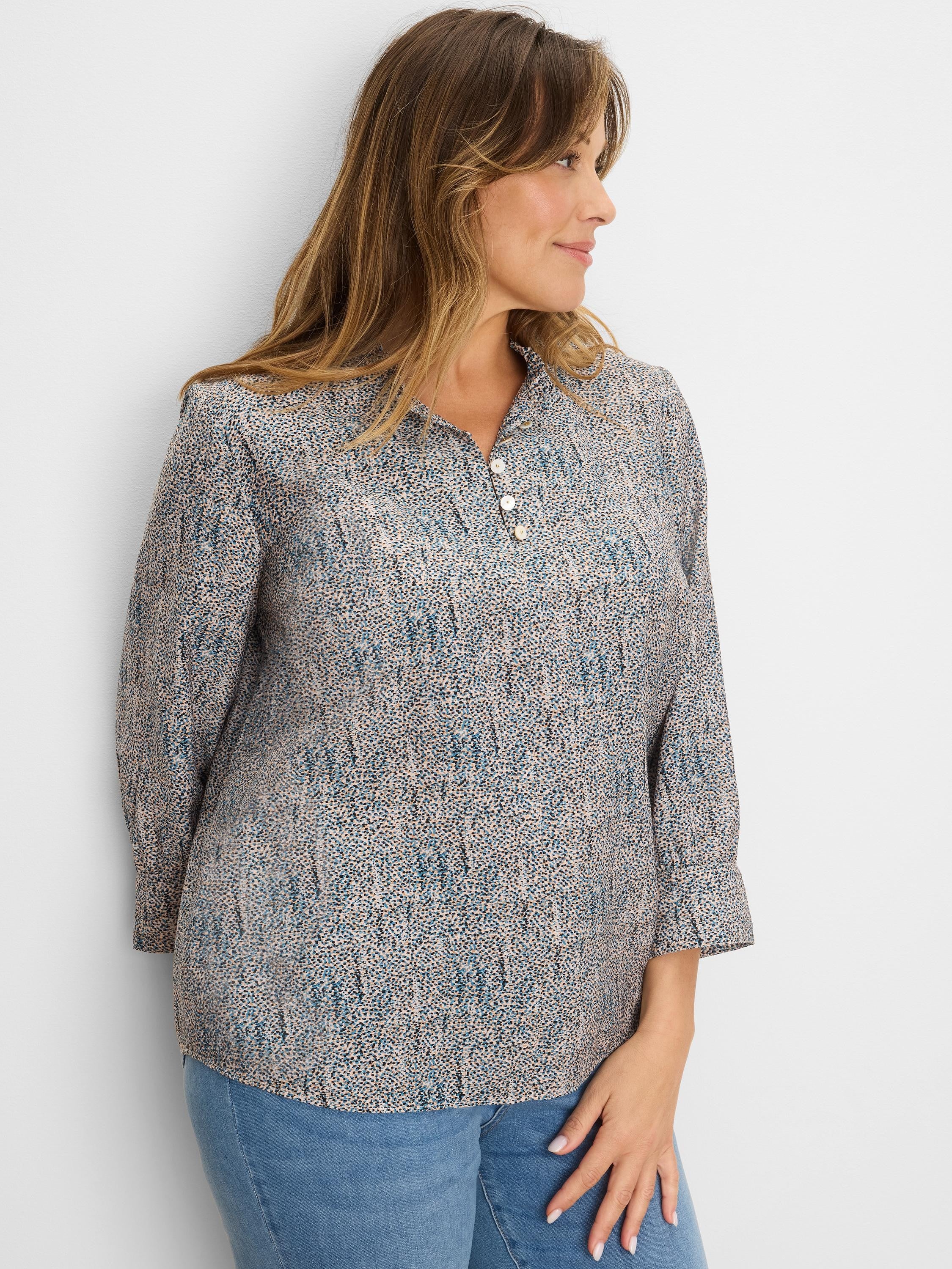 Cream top with blue, brown, black speckles. Ruffled neck, 3-button placket, 3/4 cuffed sleeves.