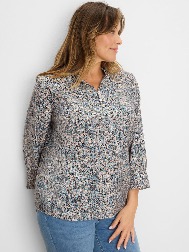 Cream top with blue, brown, black speckles. Ruffled neck, 3-button placket, 3/4 cuffed sleeves.