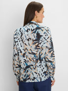 Light blue crinkled shirt with an abstract pattern of dark blue, teal, orange, and black brushstrokes. Scalloped collar.