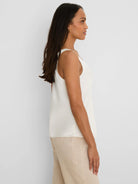 Creamy white glossy tank top with subtle lace trim on the V-neckline and straps.