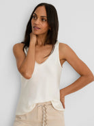 Ivory V-neck tank with a glossy finish & lace trim.