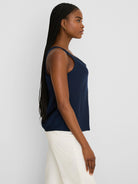 Navy blue sleeveless tank top with black lace trim along the scoop neckline.