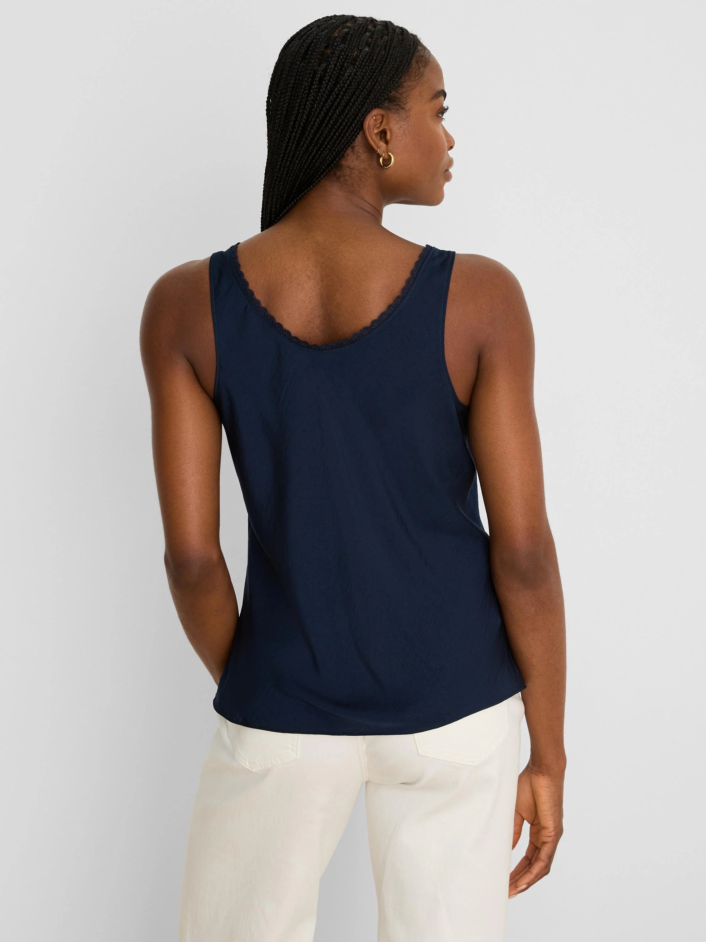 Navy blue tank top with delicate lace trim along the curved back neckline, shown from behind on a model.