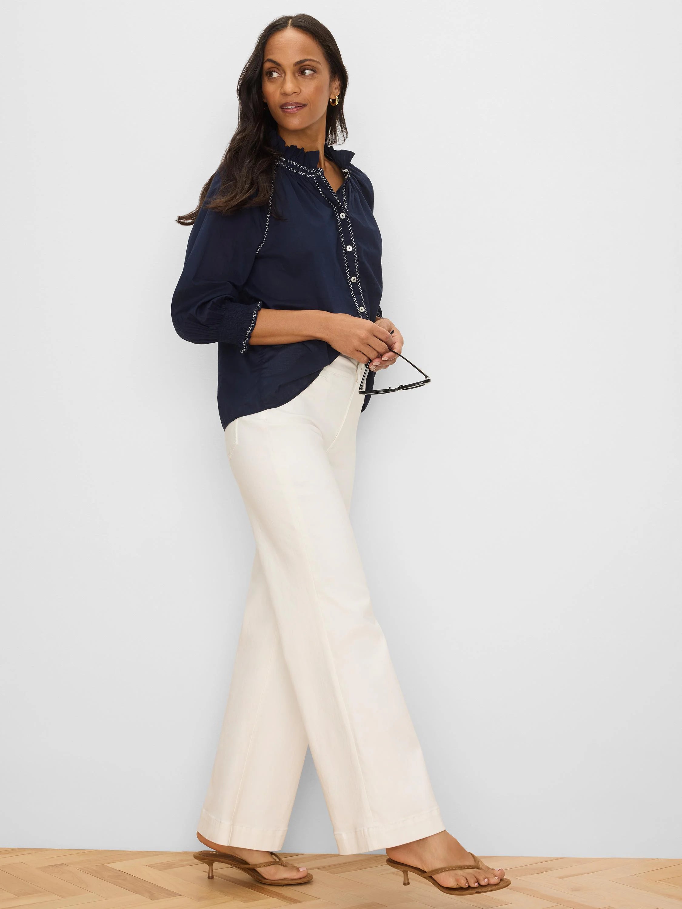 Navy crinkle shirt with white zig-zag stitching on collar, placket, and smocked cuffs.