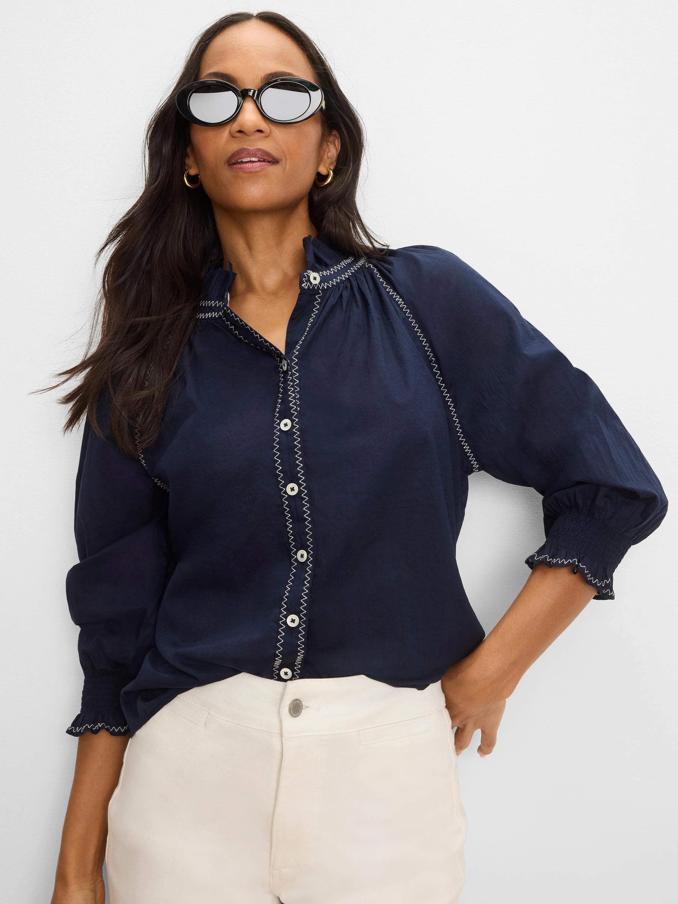 Navy blue crinkle shirt with white zig-zag stitching on placket, ruffled collar, and sleeves. White buttons & smocked cuffs.