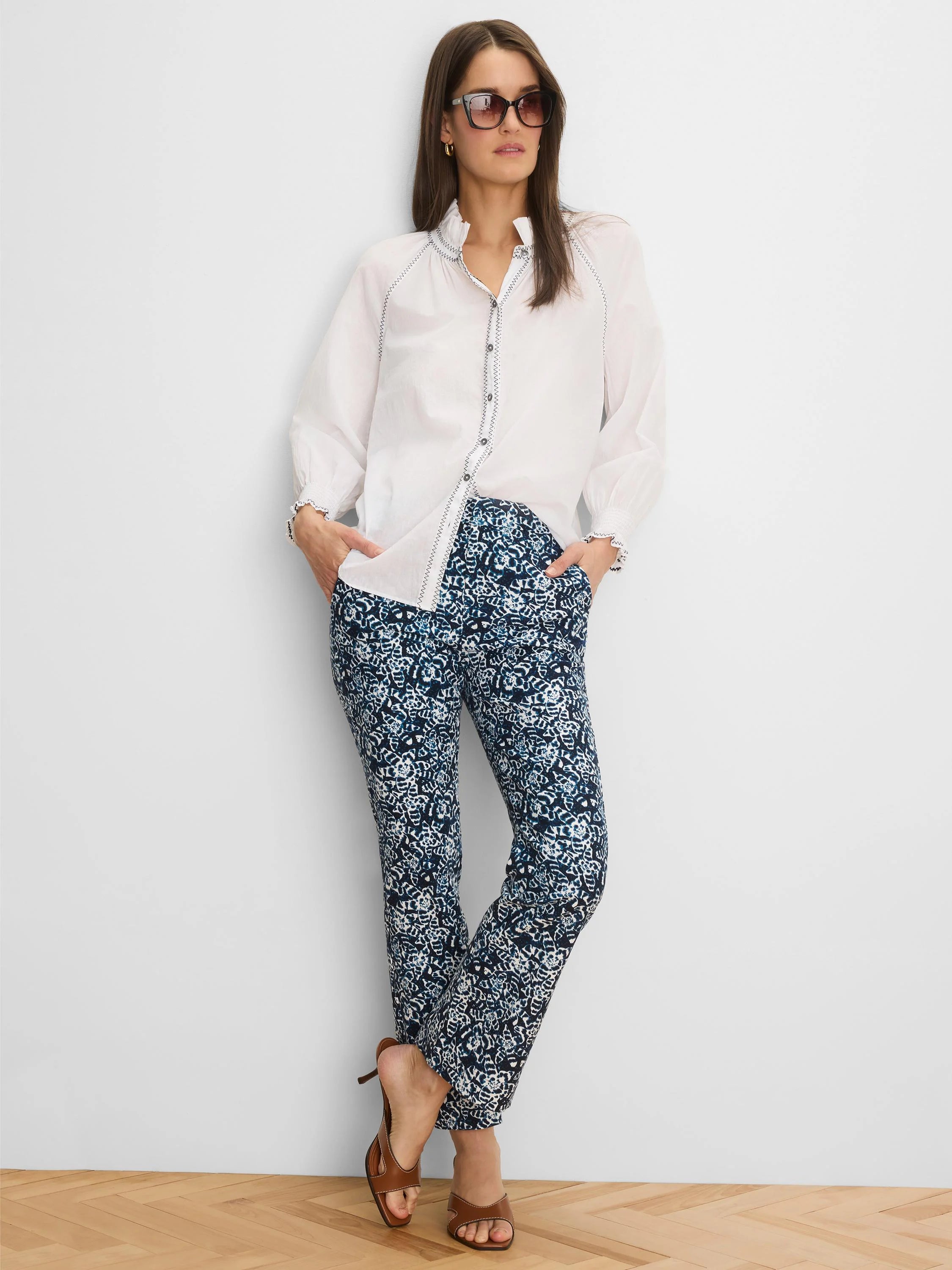 White crinkle shirt featuring dark zig-zag stitching on the ruffled collar, button placket, and elasticized cuffs.