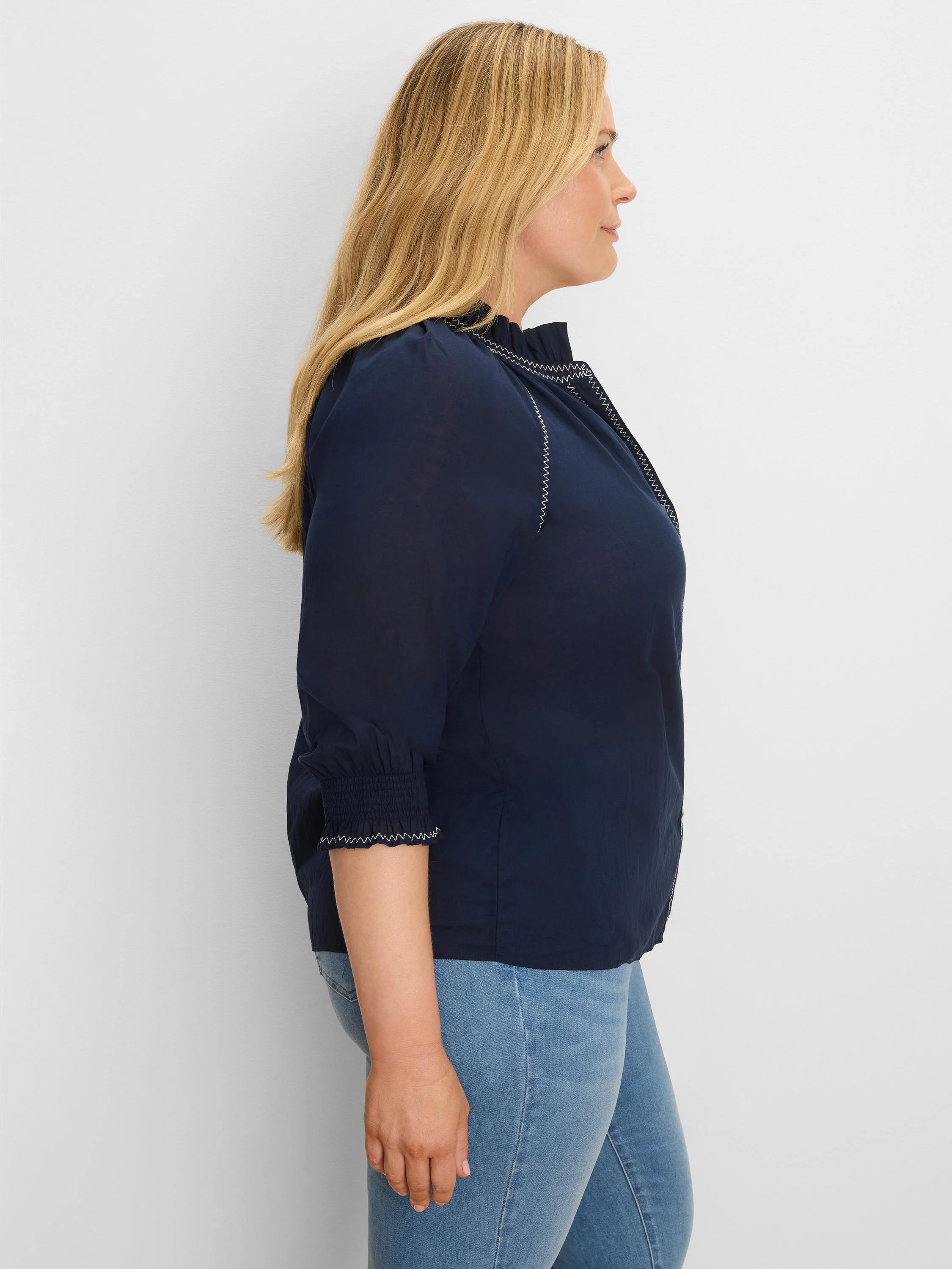 Navy crinkle shirt with white zig-zag stitching on ruffled collar, front, & smocked 3/4 cuffs.
