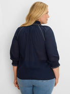 Navy blue cotton crinkle shirt with white zig-zag stitching on shirred mock neck and 3/4 cuffs.