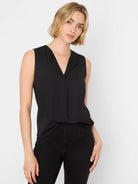 Black sleeveless V-neck top with a collar and hidden button placket. It has a loose, drapey fit.