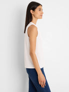 Light cream sleeveless top with a round neck.