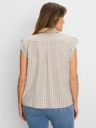 Beige linen resort shirt with shimmering white vertical stripes, cap sleeves, and shoulder tabs, viewed from back.