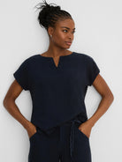 Dark navy linen tee with a split V-neck and short, loose sleeves.