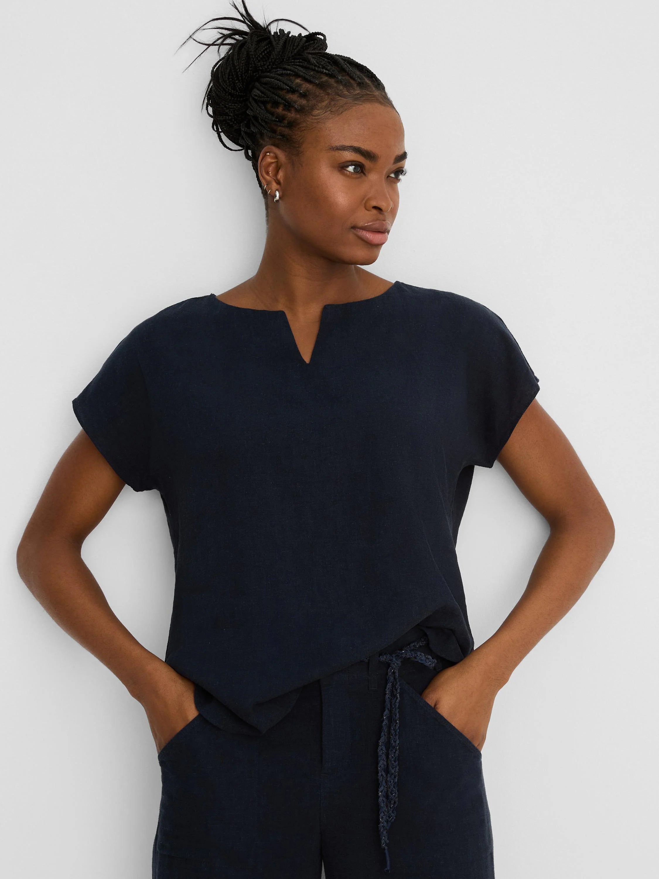 Dark navy linen tee with a split V-neck and short, loose sleeves.