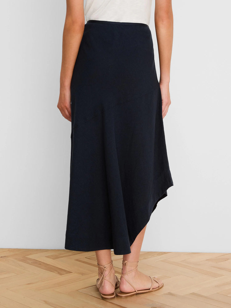 Navy linen midi skirt with a draped, asymmetrical hem.