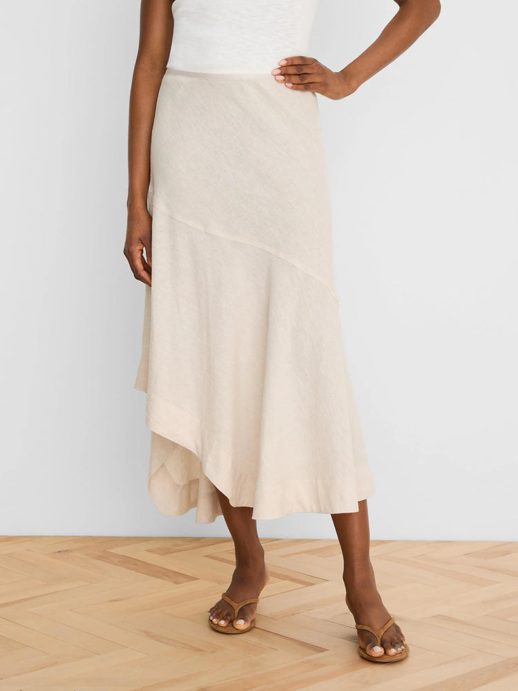 Pale beige linen midi skirt with an asymmetrical, draped hem and diagonal seam.