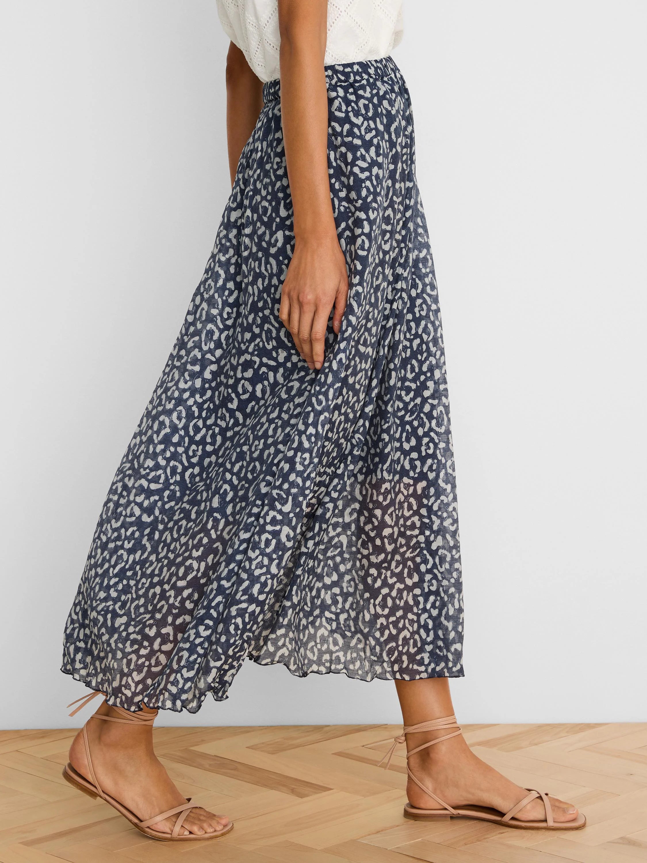 Navy crinkle skirt with a flowy silhouette, featuring a light grey sketchy leopard print and an elasticated waist.