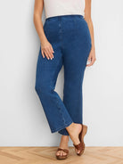 Medium blue high-waist bootcut jeans with visible front and back seams, ending above the ankle.