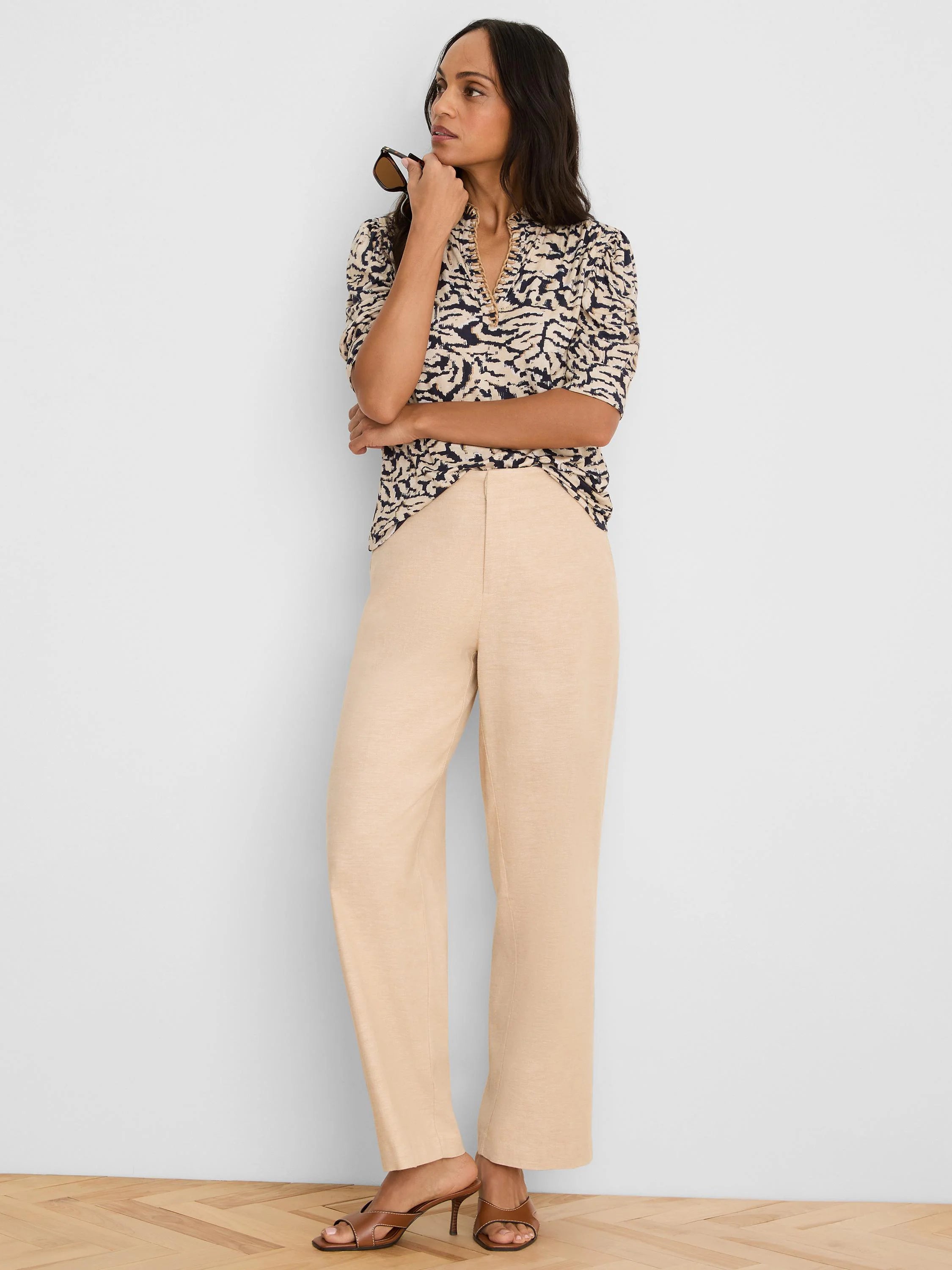 Light beige wide leg linen pants, with a textured fabric and a relaxed, straight cut.