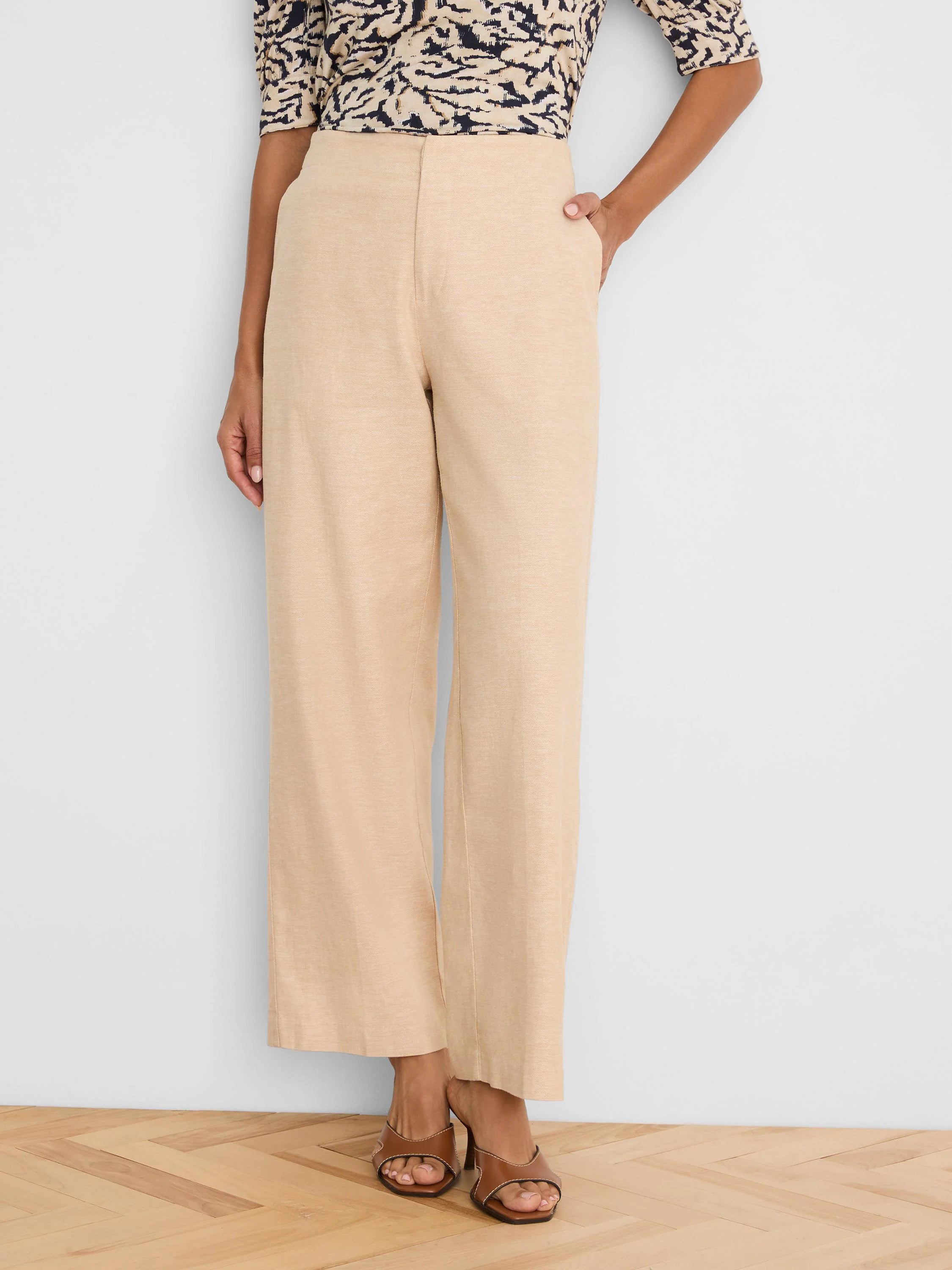 Light beige wide-leg linen pants with a visible front seam and side pockets.