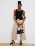 Light beige drapey wide leg cargo ankle pants with elastic waist and side pockets.
