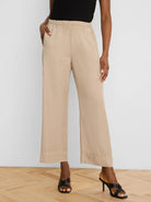 Light tan wide-leg drapey ankle pants with an elastic waist and side pockets.