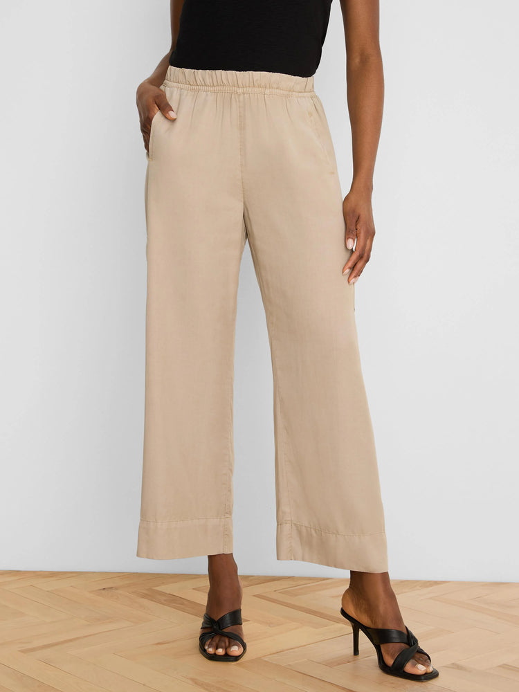 Light tan wide-leg drapey ankle pants with an elastic waist and side pockets.