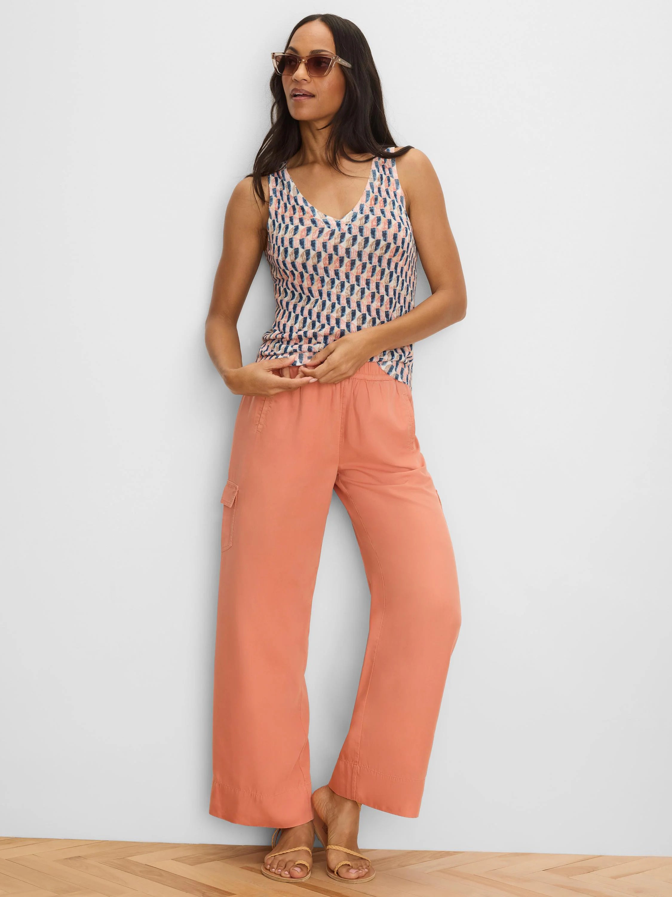 Peach wide-leg drapey cargo ankle pants with a flap pocket on the thigh.