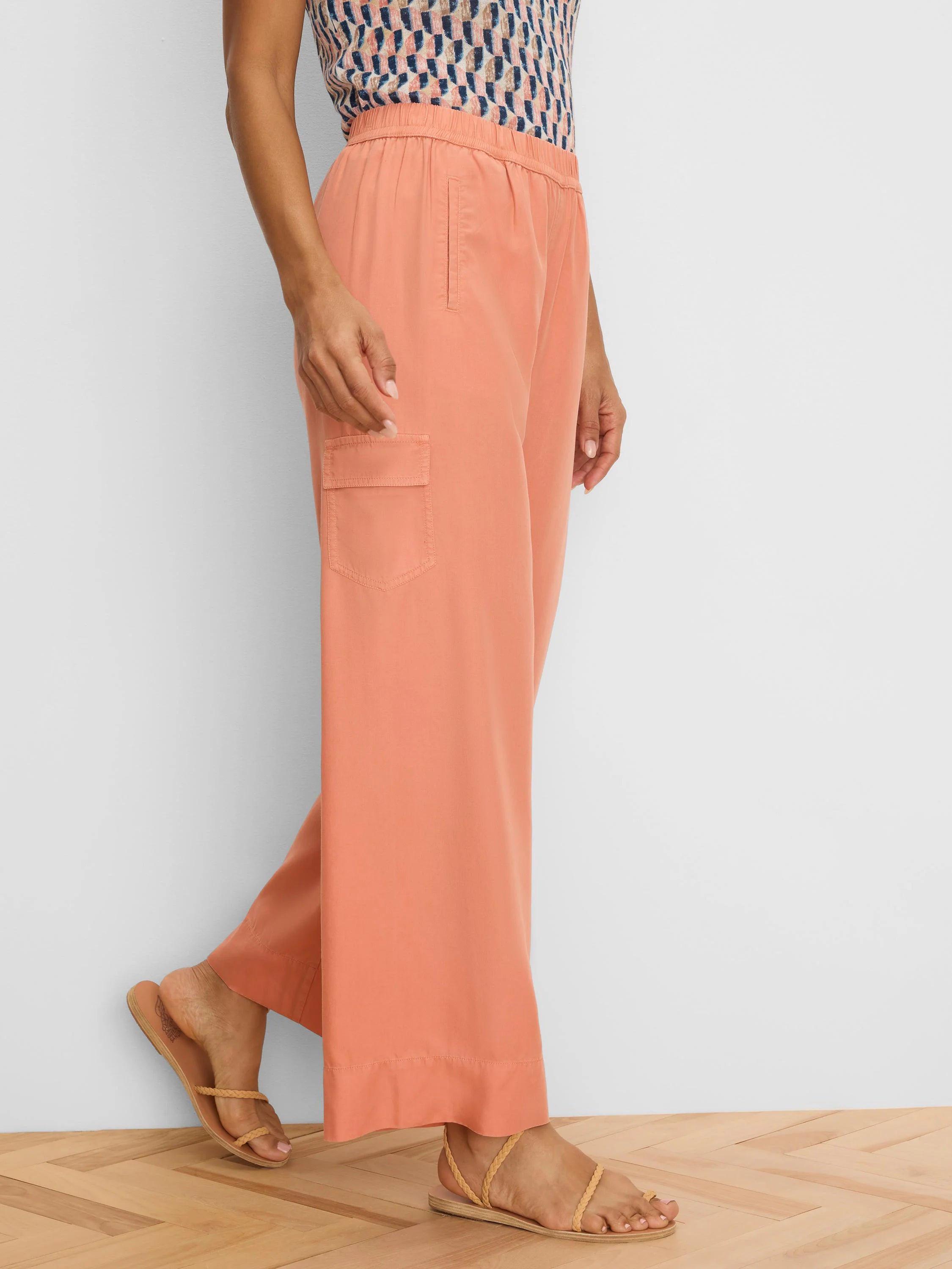 Coral wide-leg drapey cargo ankle pants with an elastic waist and a side flap pocket.