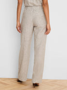 Light brown wide leg linen pants with white vertical stripes, elasticized back waist.