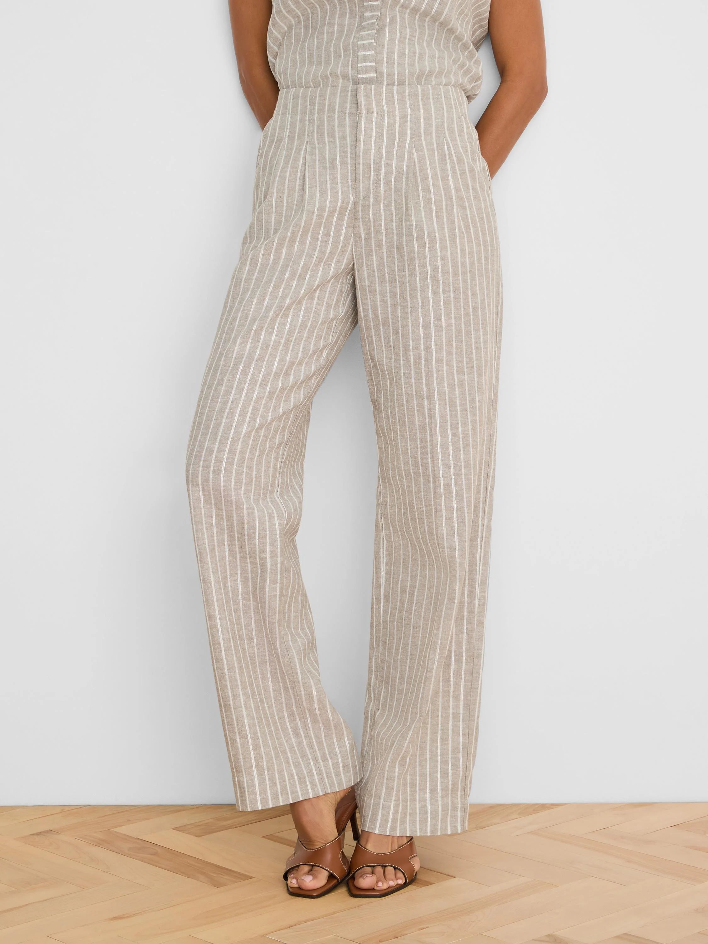 Tan wide-leg linen pants with thin white vertical stripes.