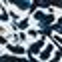 Abstract pattern of irregular dark blue and white shapes, resembling a mottled fabric.