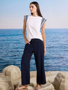 Dark blue wide-leg linen crop pants with a braided drawstring waist and side pockets.