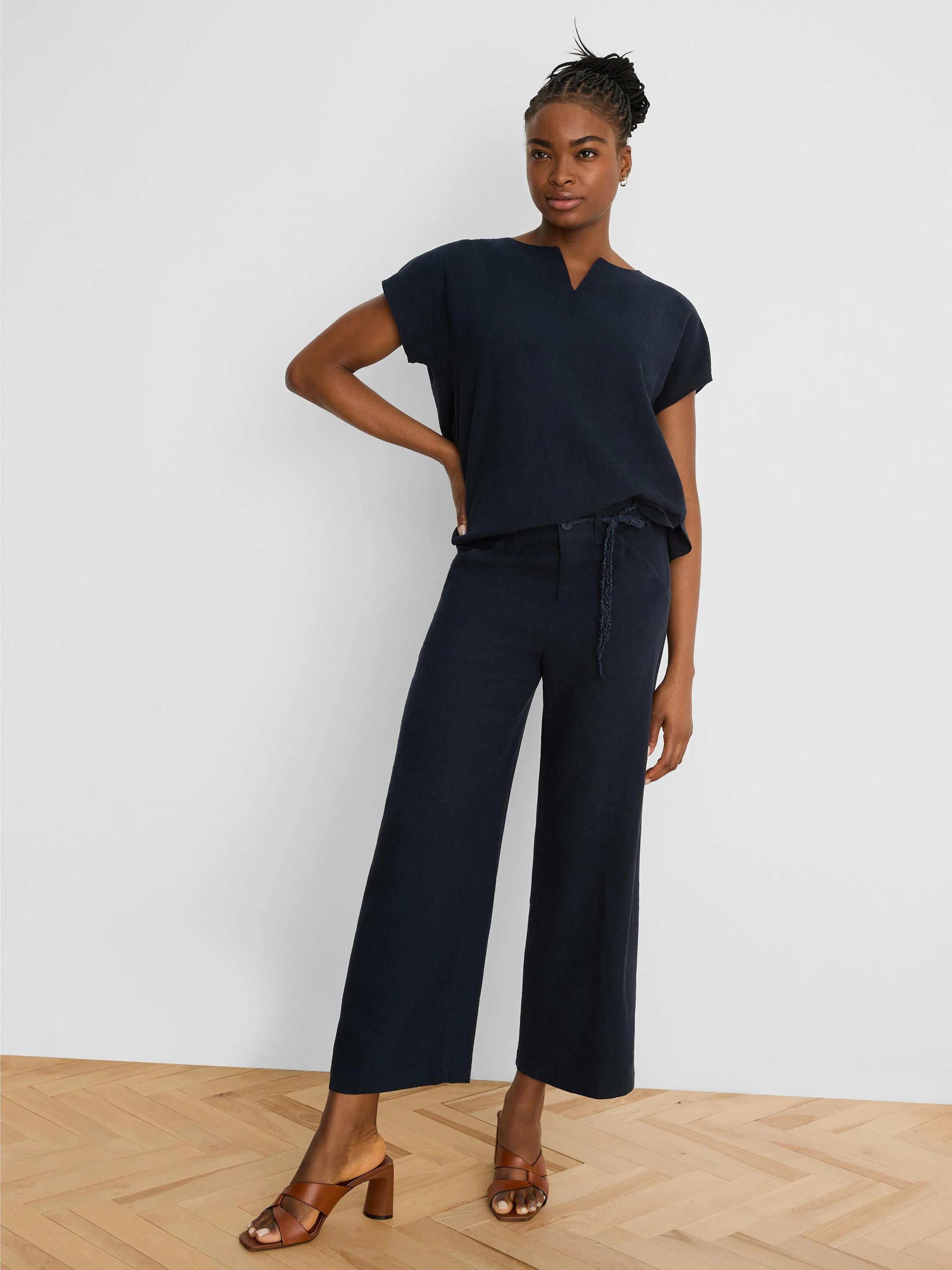 Dark navy wide-leg linen crop pants with a braided self-tie belt.