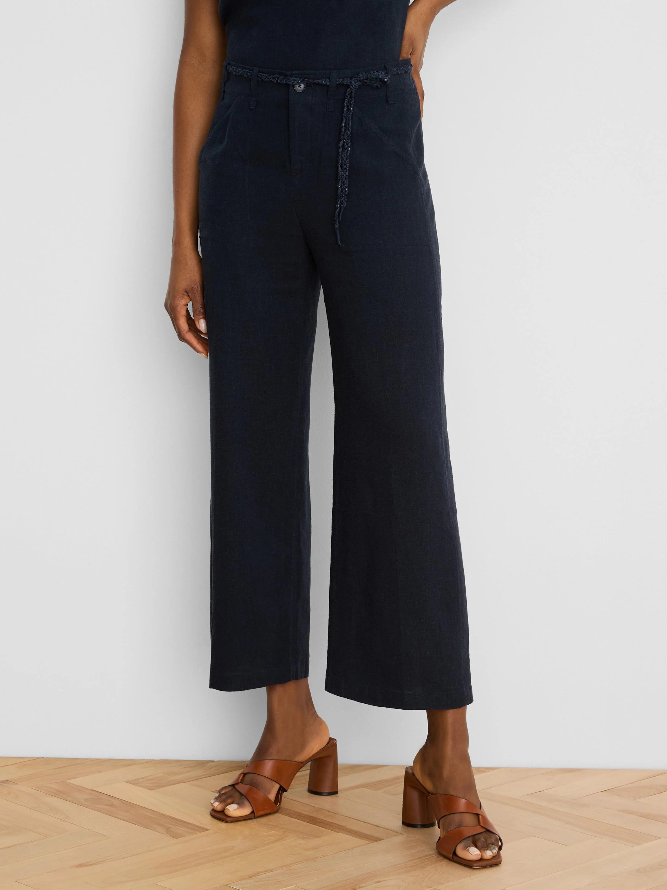Navy wide-leg cropped linen pants with a braided self-fabric belt.