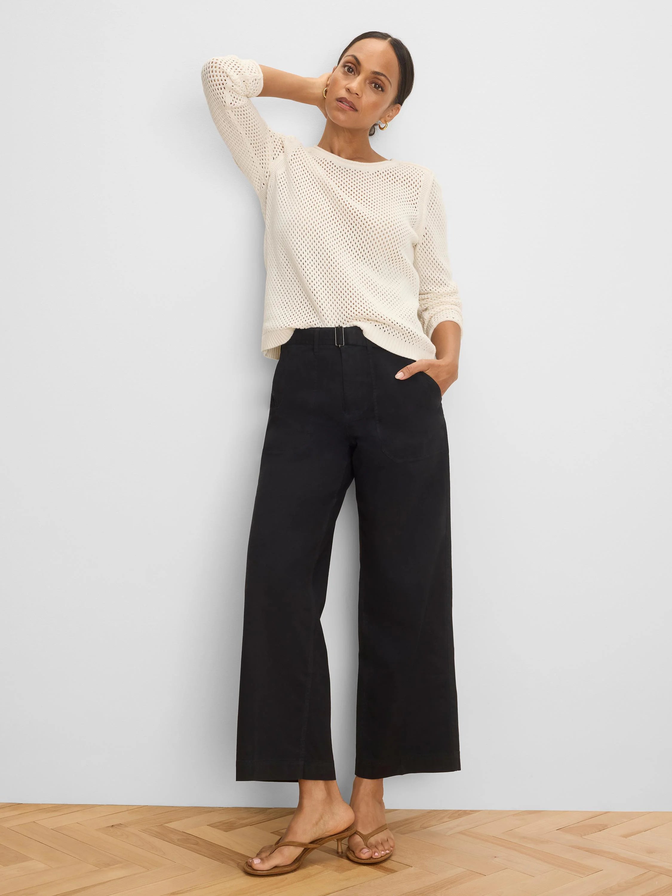 Black wide-leg belted ankle pants with a rectangular metal buckle.