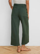 Dark green wide-leg ankle pants. Back view shows patch pockets and belt loops.