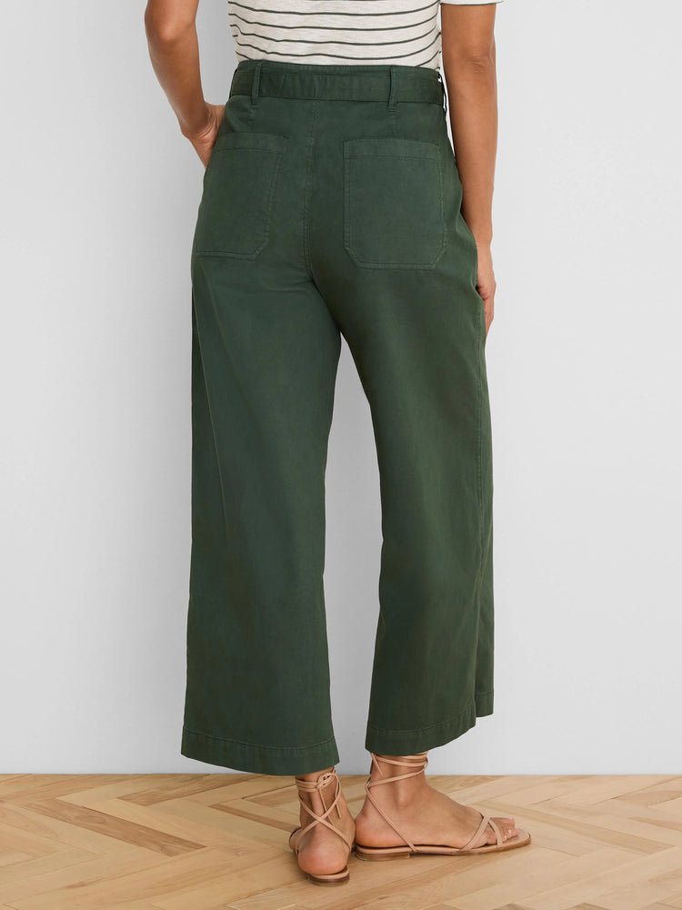 Dark green wide-leg ankle pants. Back view shows patch pockets and belt loops.