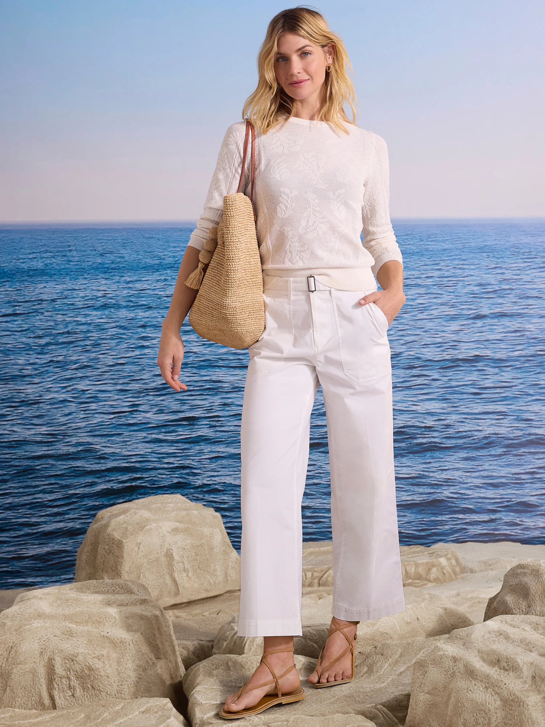 White wide-leg ankle pants with a belted waist and black rectangular buckle.